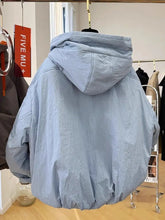 Light blue hooded jacket on a hanger